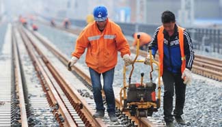Workers adjust Wuhan-Jiujiang Passenger Railway in Jiangxi