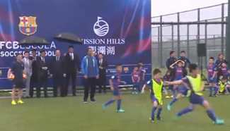 Ronaldinho plays football with Chinese kids