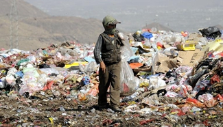 Boys searche for recyclable items in garbage dump of Yemen