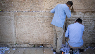 Employees remove notes placed in Western Wall in Jerusalem
