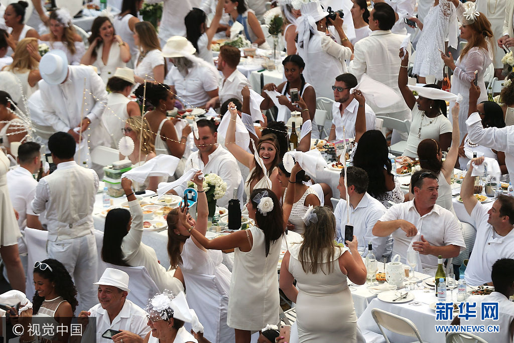當地時間2017年8月22日，美國紐約，在紐約的林肯藝術中心，數千人參加了一年一度的白色長街宴。***_***NEW YORK, NY - AUGUST 22: Thousands of diners wave their napkins at the start of the annual 'Diner en Blanc' (Dinner in White) at Lincoln Center on August 22, 2017 in New York City. Diner en Blanc began in France nearly 30 years ago. Attendees all must wear white clothing and bring their own picnic food and white tables clothes. It's the second time the event, which is held in cities around the world, has been held at Lincoln Center.(Photo by Spencer Platt/Getty Images)
