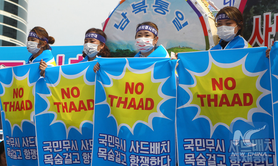 People from Seongju county hold banners to protest against the deployment of the Terminal High Altitude Area Defense (THAAD), during a rally in Seoul, capital of South Korea, on July 21, 2016.