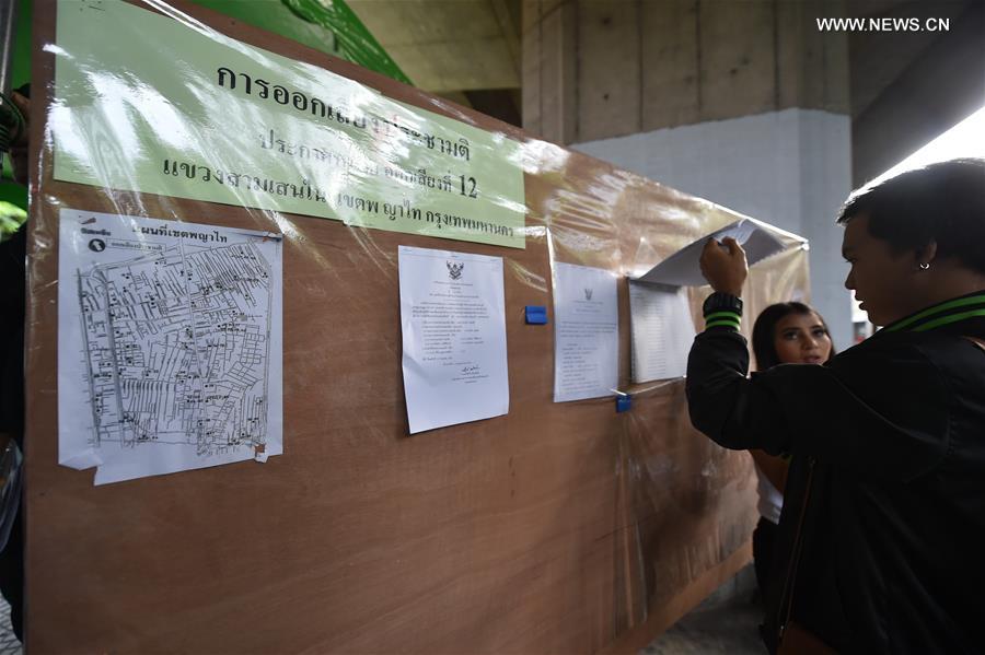 A journalist checks information at a polling station in Bangkok, Aug. 7, 2016. A journalist checks information at a polling station in Bangkok, Aug. 7, 2016.