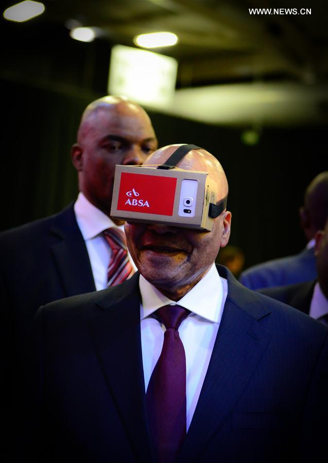 File photo taken on April 7, 2016 shows South African President Jacob Zuma tries a VR device provided by Amalgamated Banks of South Africa (ABSA) during the launch of the eChannel Pilot Project of the Department of Home Affairs at Gallagher Convention Center in Midrand, near Johannesburg, South Africa. 