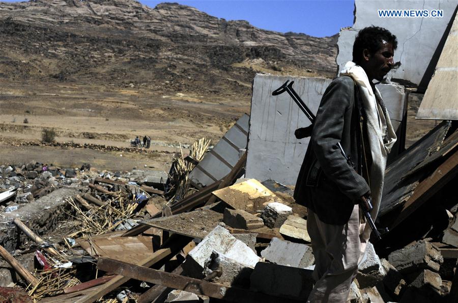 A man stands on rubble of a funeral house that was hit in airstrike in Arhab district, about 40 km north of Sanaa, capital of Yemen, on Feb. 16, 2017. 