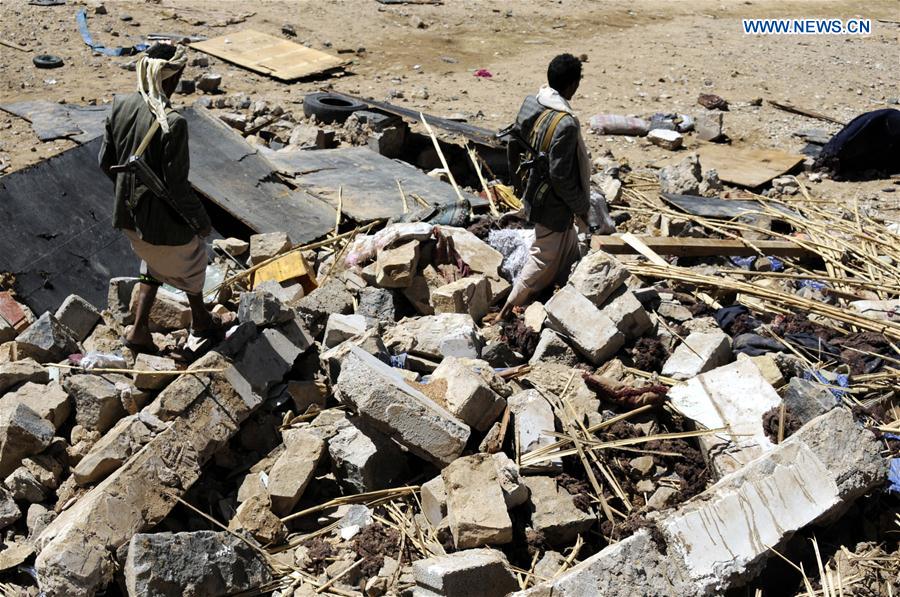 A man stands on rubble of a funeral house that was hit in airstrike in Arhab district, about 40 km north of Sanaa, capital of Yemen, on Feb. 16, 2017.