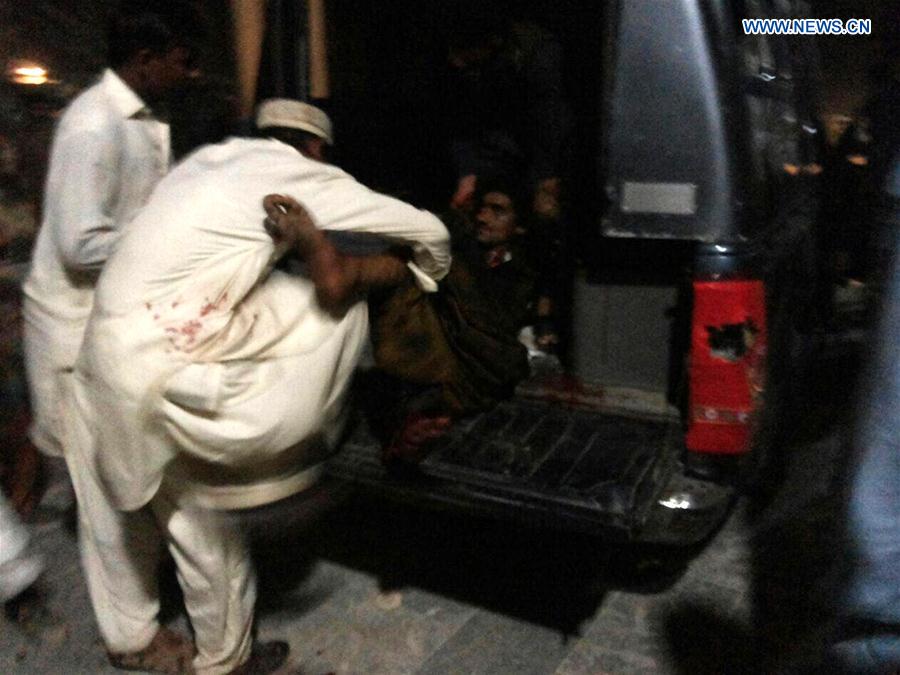 Photo taken with mobile phone shows people transfer an injured man after a blast at a shrine in Sehwan town of Jamshoro, a district in southern Pakistan's Sindh province on Feb. 16, 2017.