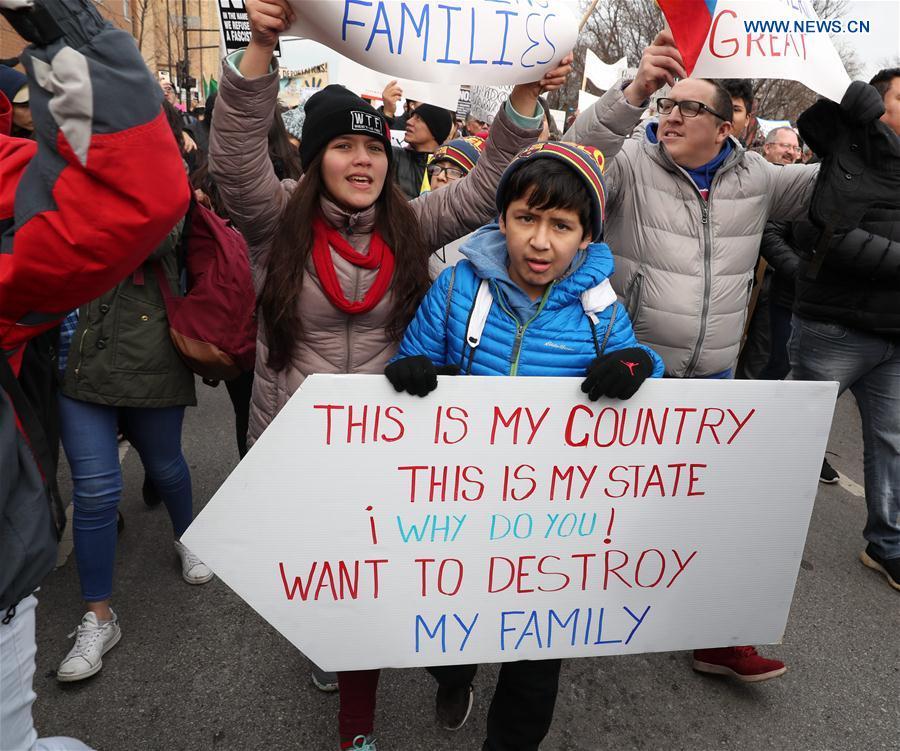 People holding postcards participate in a protest to demonstrate how important immigrants are to America's economy on the Day Without Immigrants at Union Park of Chicago, the United States, Feb. 16, 2017.