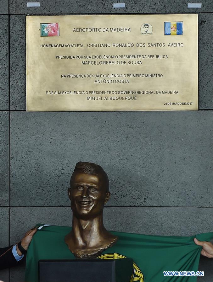 A statue of Portuguese footballer Cristiano Ronaldo is unveiled during an airport renaming ceremony in Funchal March 29, 2017. Portugal on Wednesday renamed Madeira airport as Cristiano Ronaldo airport in honor of the captain of the Portuguese national football team. Funchal on Madeira Islands is the hometown of Cristiano Ronaldo. (Xinhua/Zhang Liyun) 