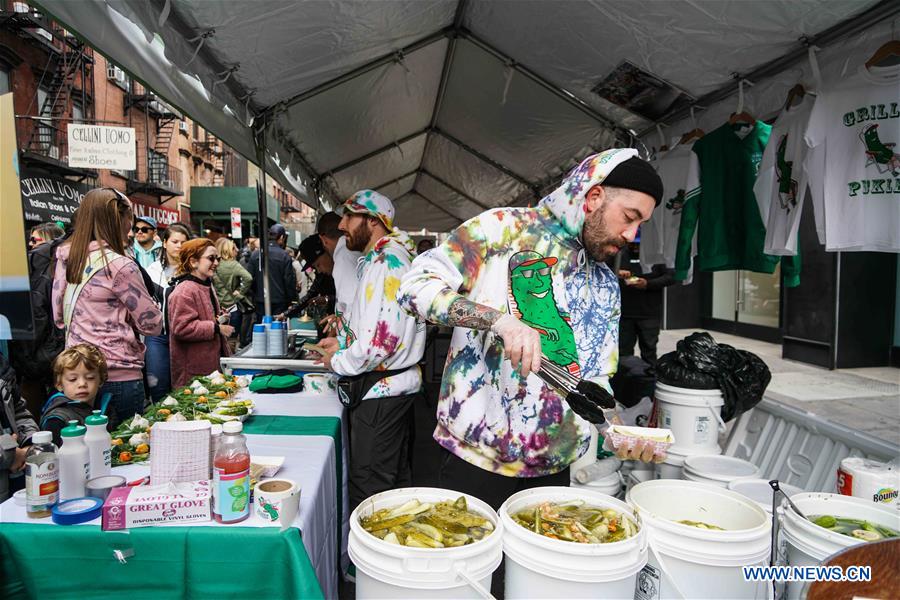 People enjoy pickles during Lower East Side Pickle Day in New York