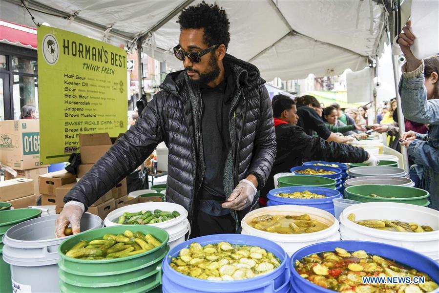 People enjoy pickles during Lower East Side Pickle Day in New York