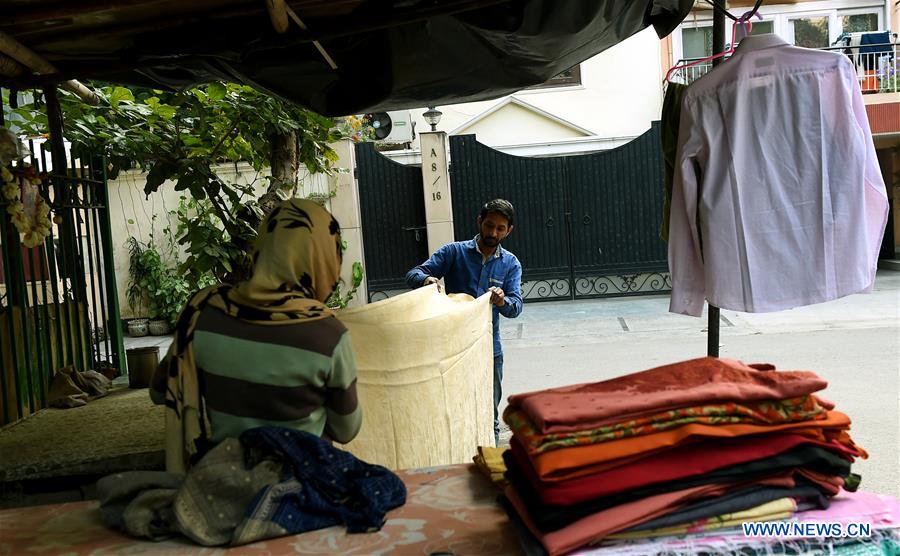Pic story street vendor makes a living by ironing clothes in New Delhi