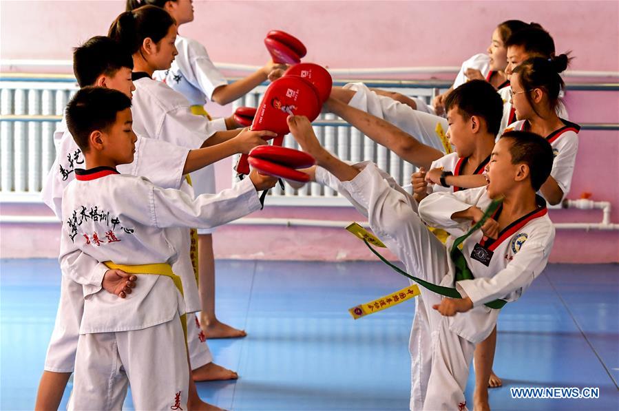 Kids do taekwondo training during summer vacation in China's Hebei