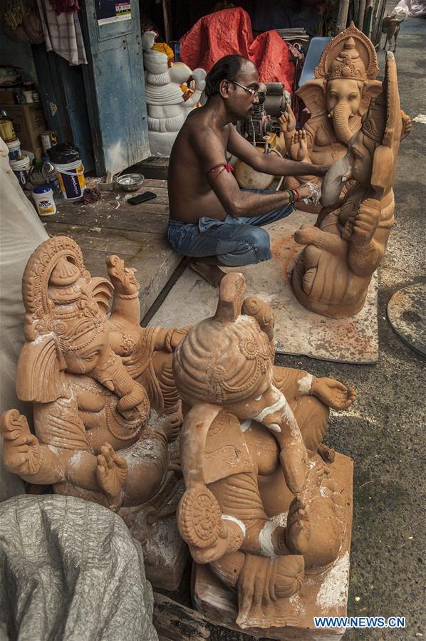 Indian artists work on statues of elephantheaded Hindu God Ganesha in