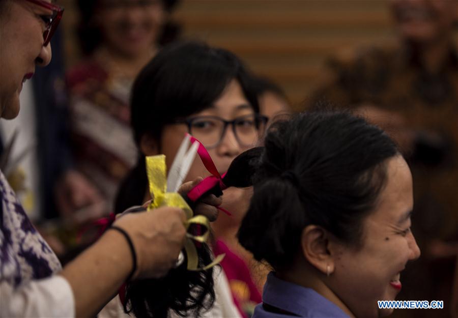 People participate in hair donation event for cancer patients in