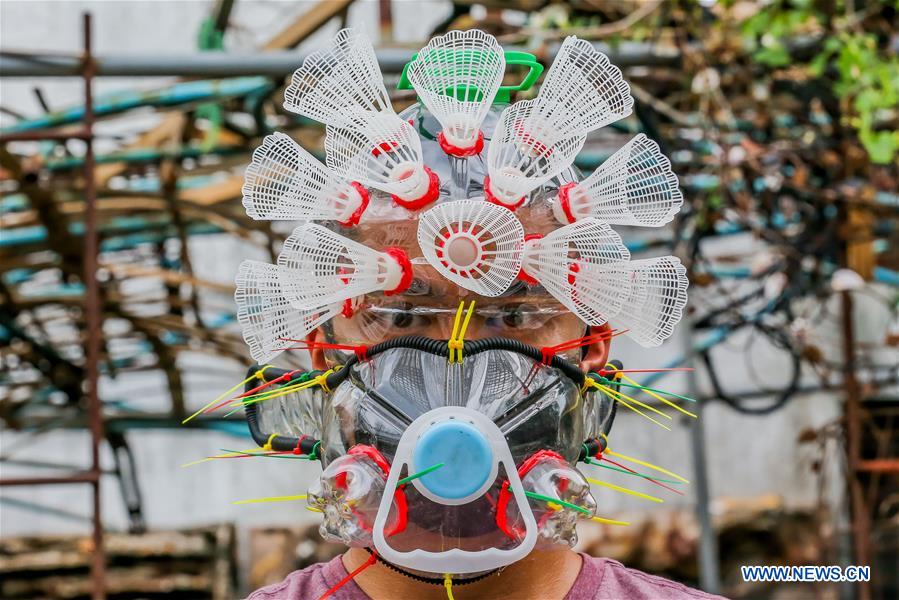 Filipino artist works on improvised face mask in Manila, the