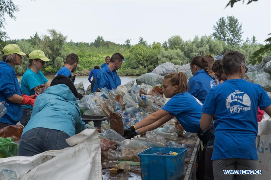 Volunteers sort plastic waste collected from River Tisza in Dombrad