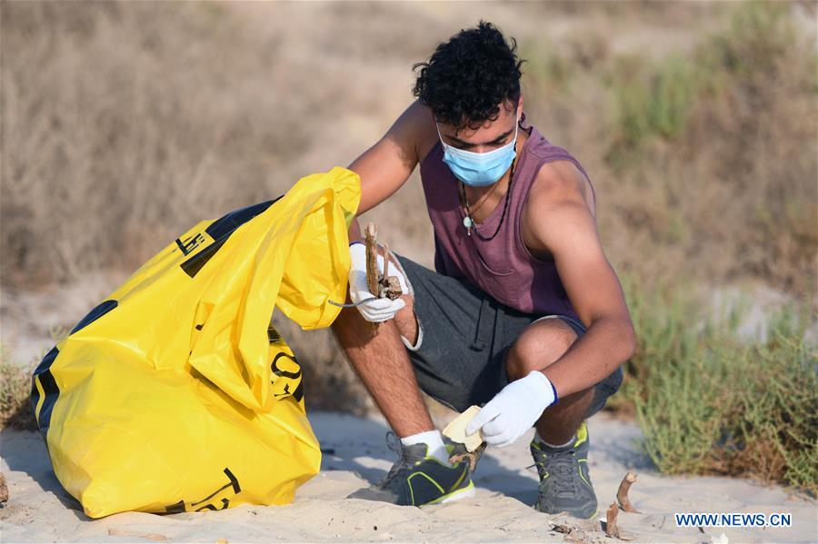 Volunteers collect garbage during beachcleanup campaign in Kuwait