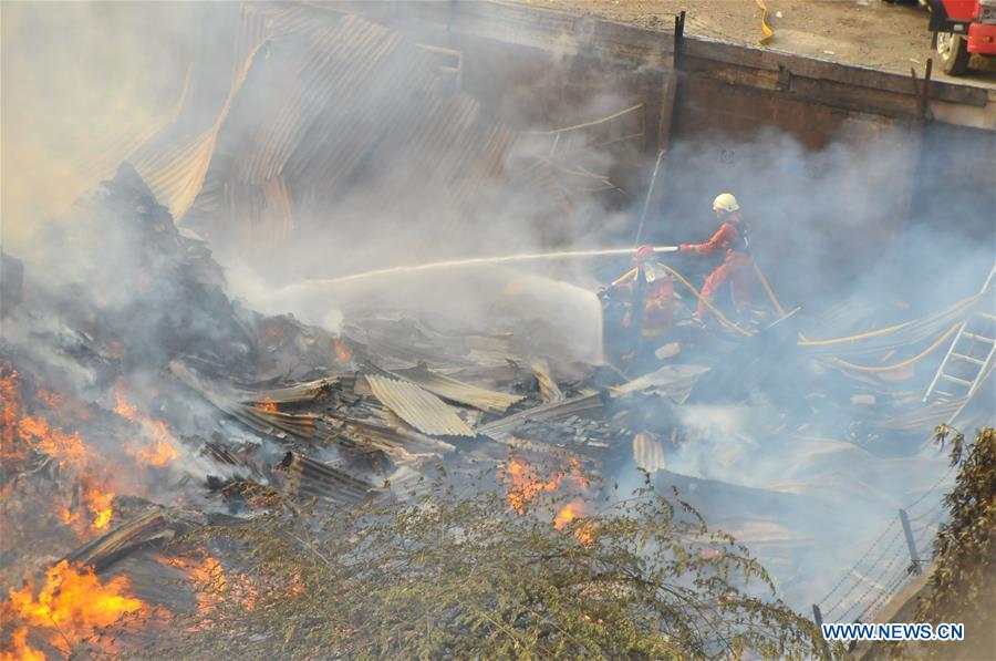 Firefighters try to extinguish fire at furniture factory in Jakarta