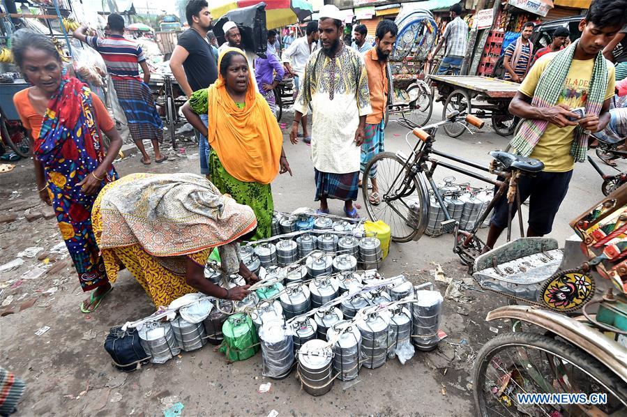 Delivery persons deliver food for officegoers in Dhaka, Bangladesh