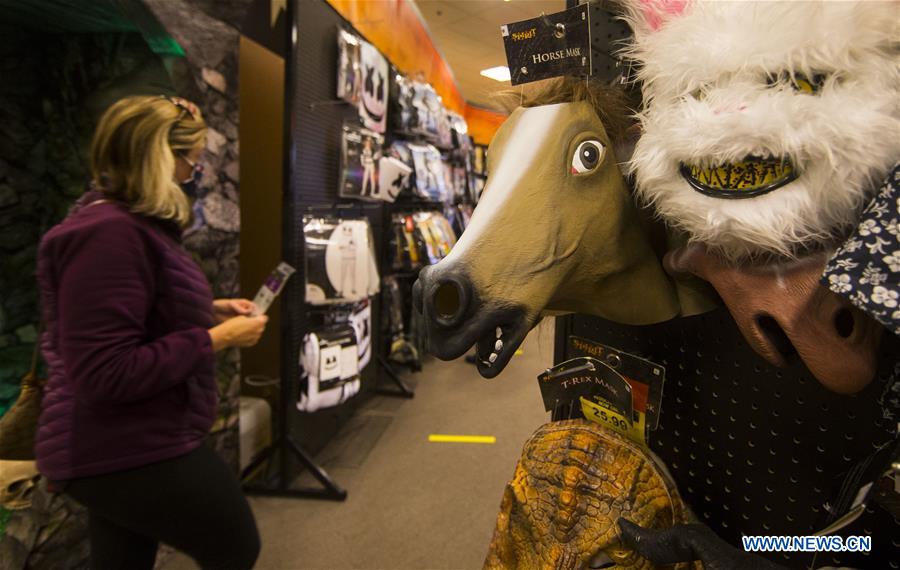People shop for decorations for Halloween in Ontario, Canada