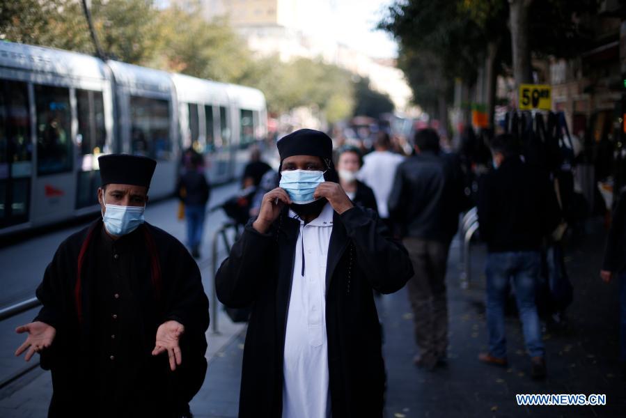 people wear face masks in jerusalem amid covid-19 pandemic