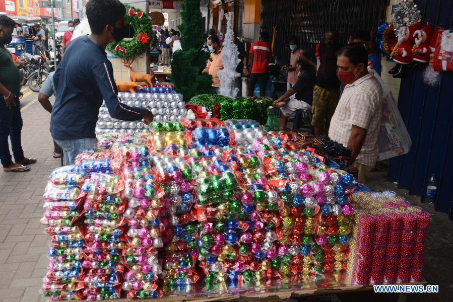 People buy Christmas decorations at market in Colombo, Sri Lanka