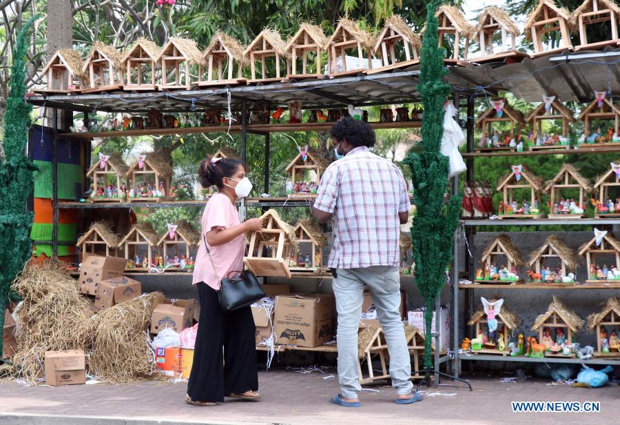 People buy Christmas decorations at market in Colombo, Sri Lanka