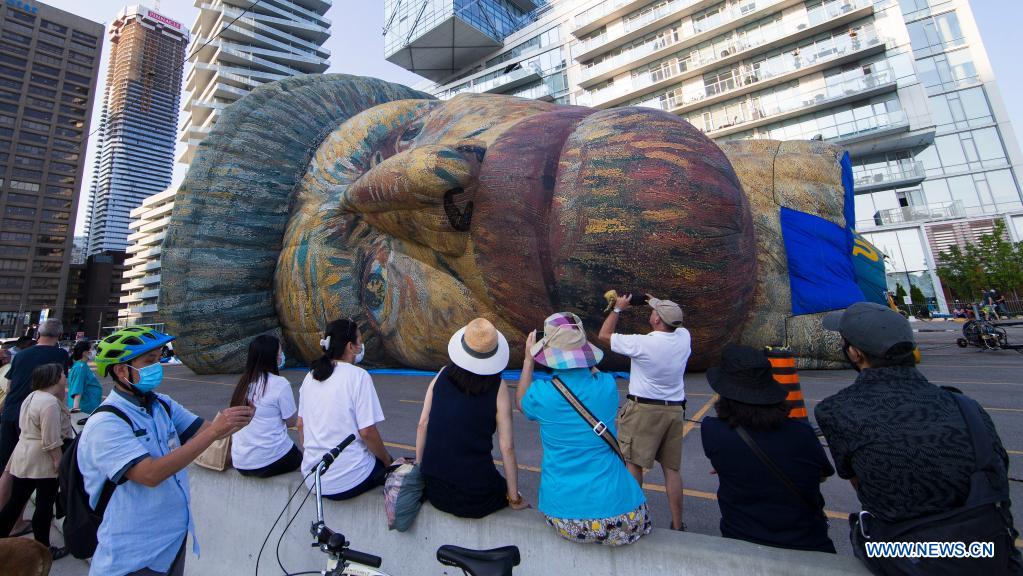 People view huge Van Gogh headshaped hot air balloon in Toronto