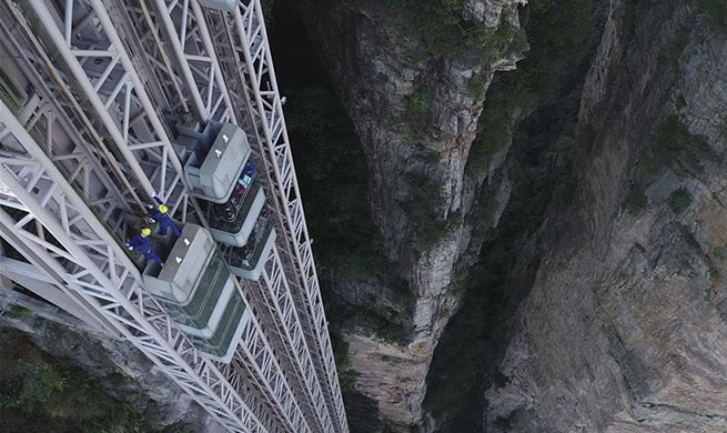 Mechanic conducts routine checks to guarantee cliffside elevator's safe operation