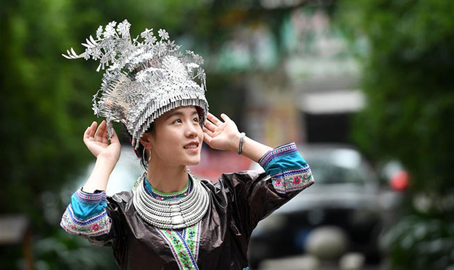 Women of Miao ethnic group wear fancy silver ornaments for decoration