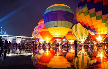 People view colorful hot air balloons in China's Guizhou
