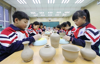 Students learn to make ceramic ware at school in China's Hebei