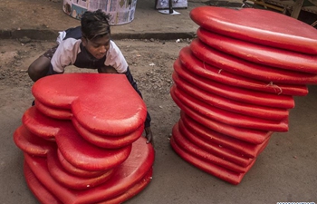 People prepare decorative items for Valentine's Day in Kolkata, India
