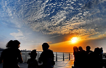 People view Tamsui River at sunset in China's Taiwan