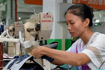 Workers make shoes at shoemaking factory in China's Fujian