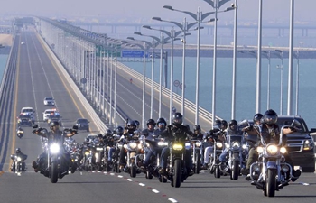 Motorcyclists ride on Sheikh Jaber Al-Ahmad Al-Sabah Causeway in Kuwait City