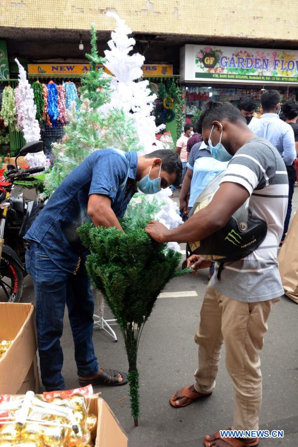 People buy Christmas decorations at market in Colombo, Sri Lanka