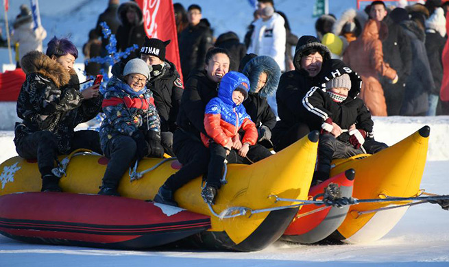 Tourists enjoy themselves on frozen Songhua River in China's Heilongjiang