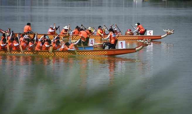 People participate in dragon boat competition in China's Ningxia