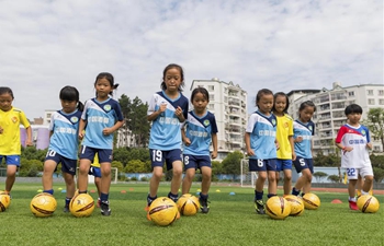 Girl students practice football in SW China's Guizhou