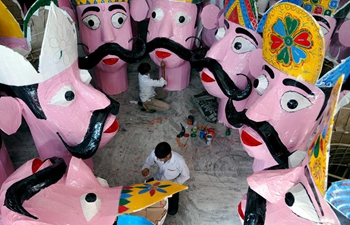 Workers prepare effigies of Demon King for upcoming Hindu festival Dussehra