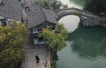 Tourists visit historical water town Wuzhen in E China