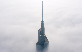 450-meter-high skyscraper piercing through fog in Nanjing