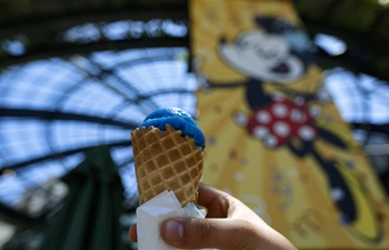 People enjoy ice cream at Disneyland in U.S.