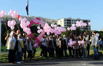 Syrians take part in rally to support early detection tests of breast cancer