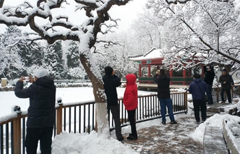 People visit Xuanwuyiyuan Garden after snow in Beijing