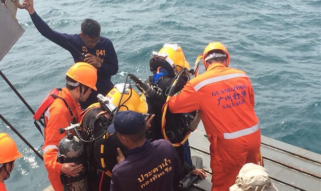 Thai and Chinese rescue team search for body trapped by wreckage in Phuket, Thailand