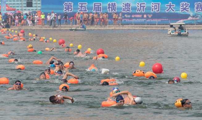 Swimming competition crossing Yihe River held in east China's Shandong