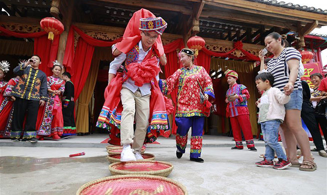 Tourists experience wedding custom of Tujia ethnic group in Zhangjiajie, China's Hunan